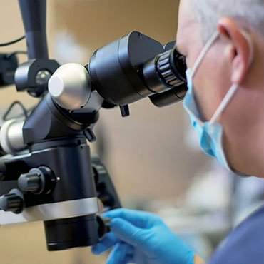 Practitioner using microscope